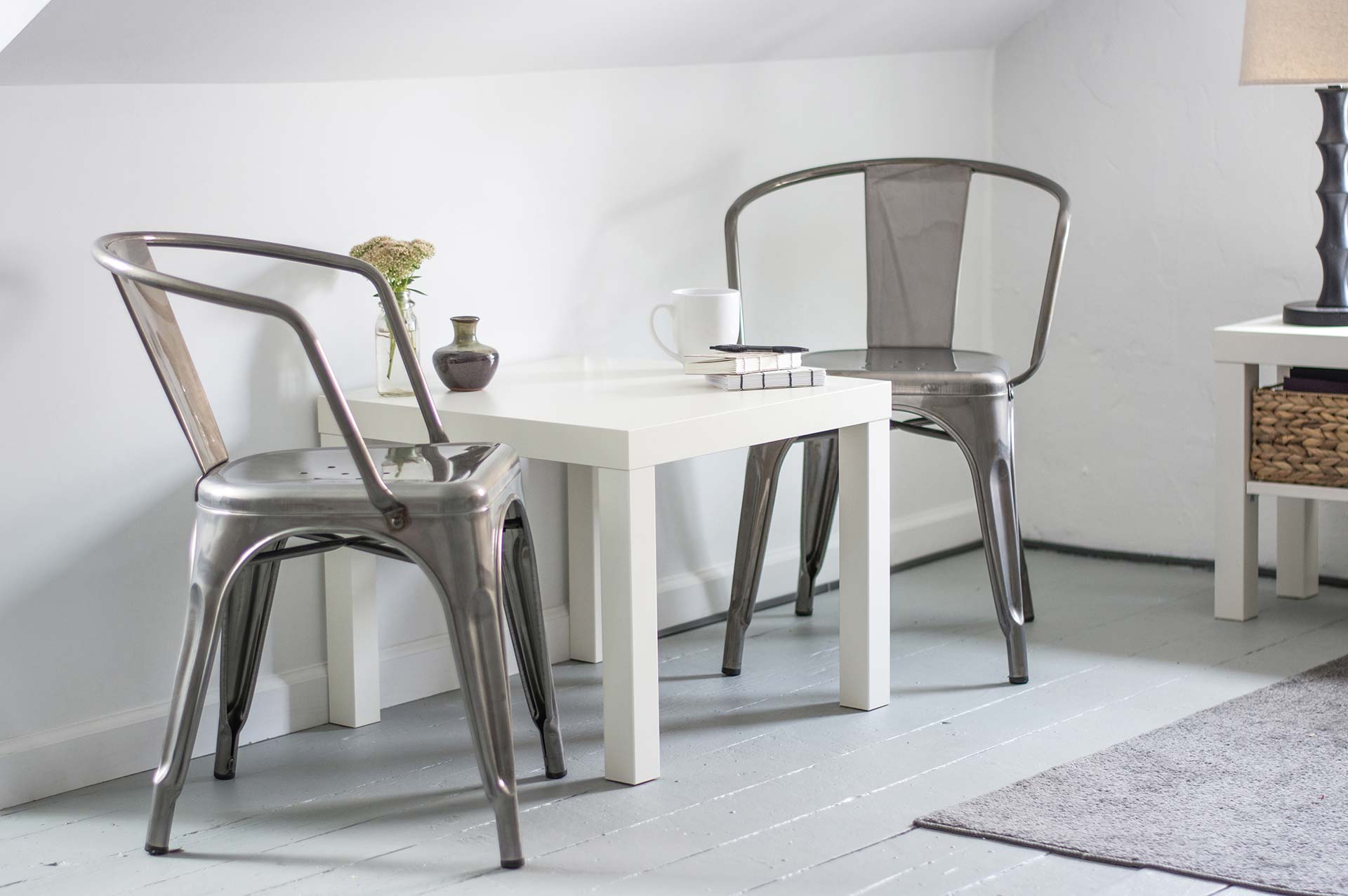White table with metal chairs, minimalist decor.